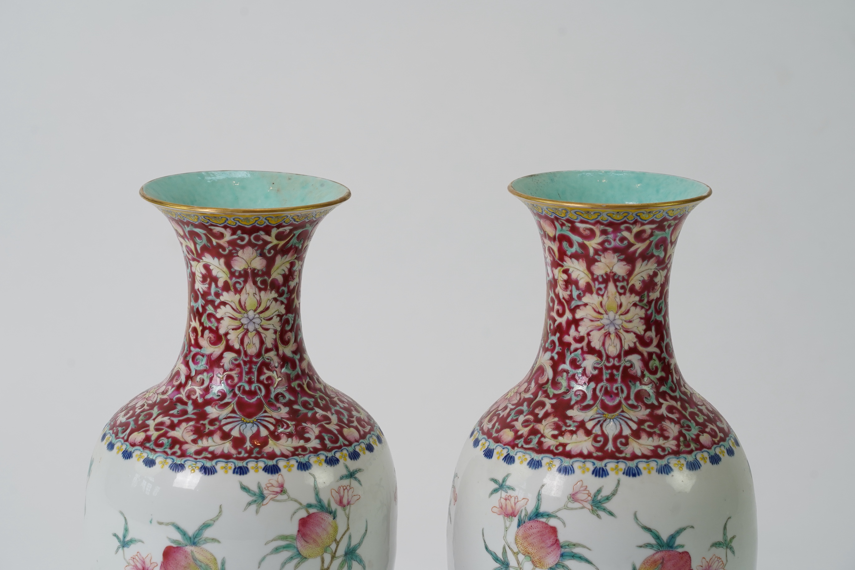 A pair of Chinese famille rose ‘sanduo’ vases, Qianlong seal mark, 19th century